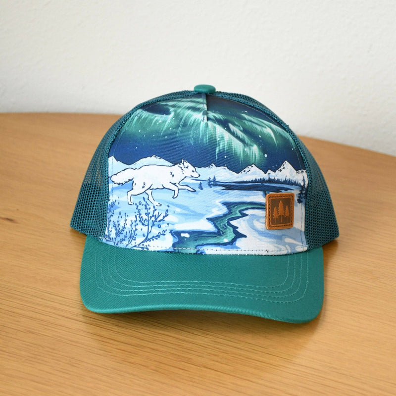 Cap with nature-themed design on a wooden surface