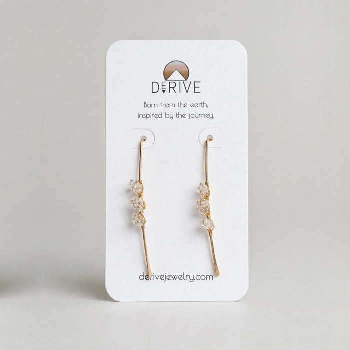 Atlantic Threader Earrings with Herkimer Diamonds in 14k gold fill with three Herkimer diamonds wire wrapped along each threader bar, on a Derive Jewelry earring card