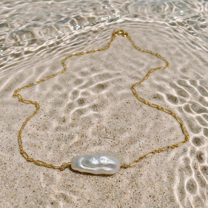 Bora Bora Necklace in 14k gold fill, styled on pale sand at the beach