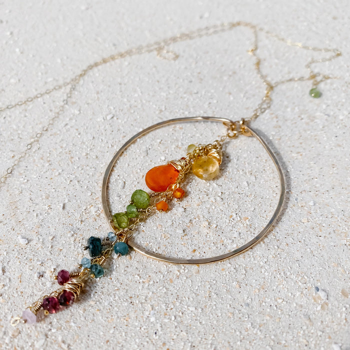 Coral Garden Hoop Necklace in 14k gold fill, styled on pale sand at the beach