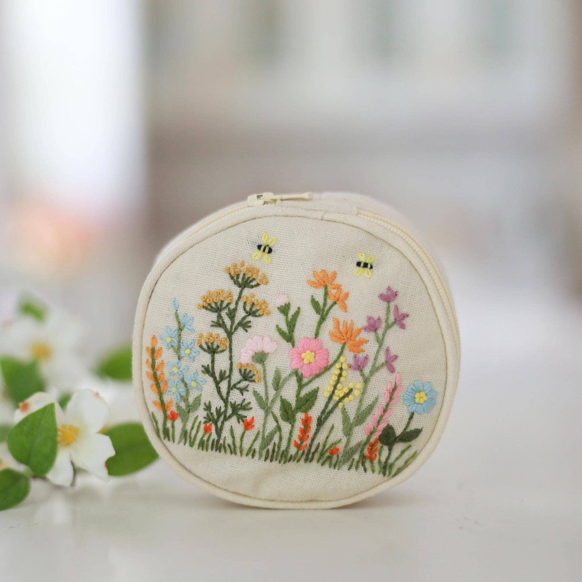 Hand embroidered jewelry pouch with wildflower and bee embroidery, front view