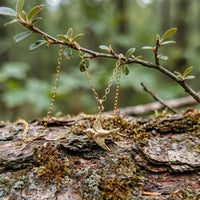 Dainty Flying Swallow Bird Necklace in 14k gold fill with a swallow bird pendant, styled on a branch