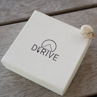 Derive Jewelry Gift Box photographed in Bora Bora with a hermit crab on the corner