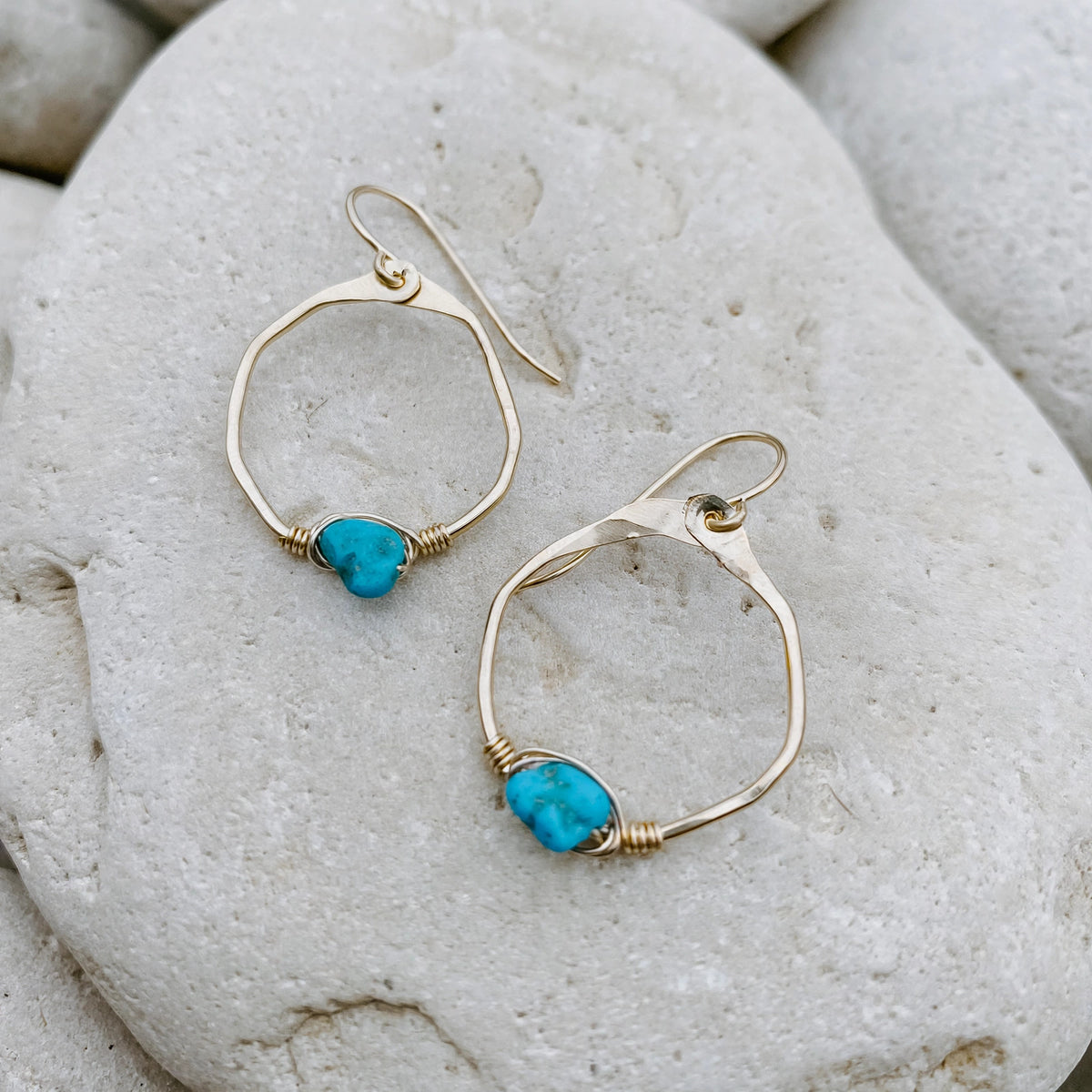 Kingman Turquoise Mini Organic Hoop Earrings in 14k gold fill, styled on pale sand at the beach