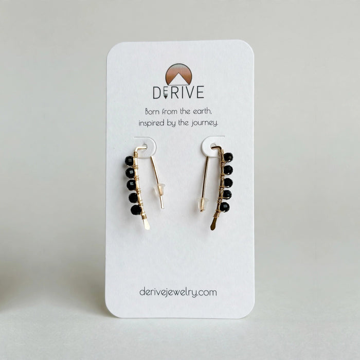 Mini Black Tourmaline Threader Earrings in 14k gold fill with faceted black tourmaline beads wire wrapped along each threader, on a Derive Jewelry earring card