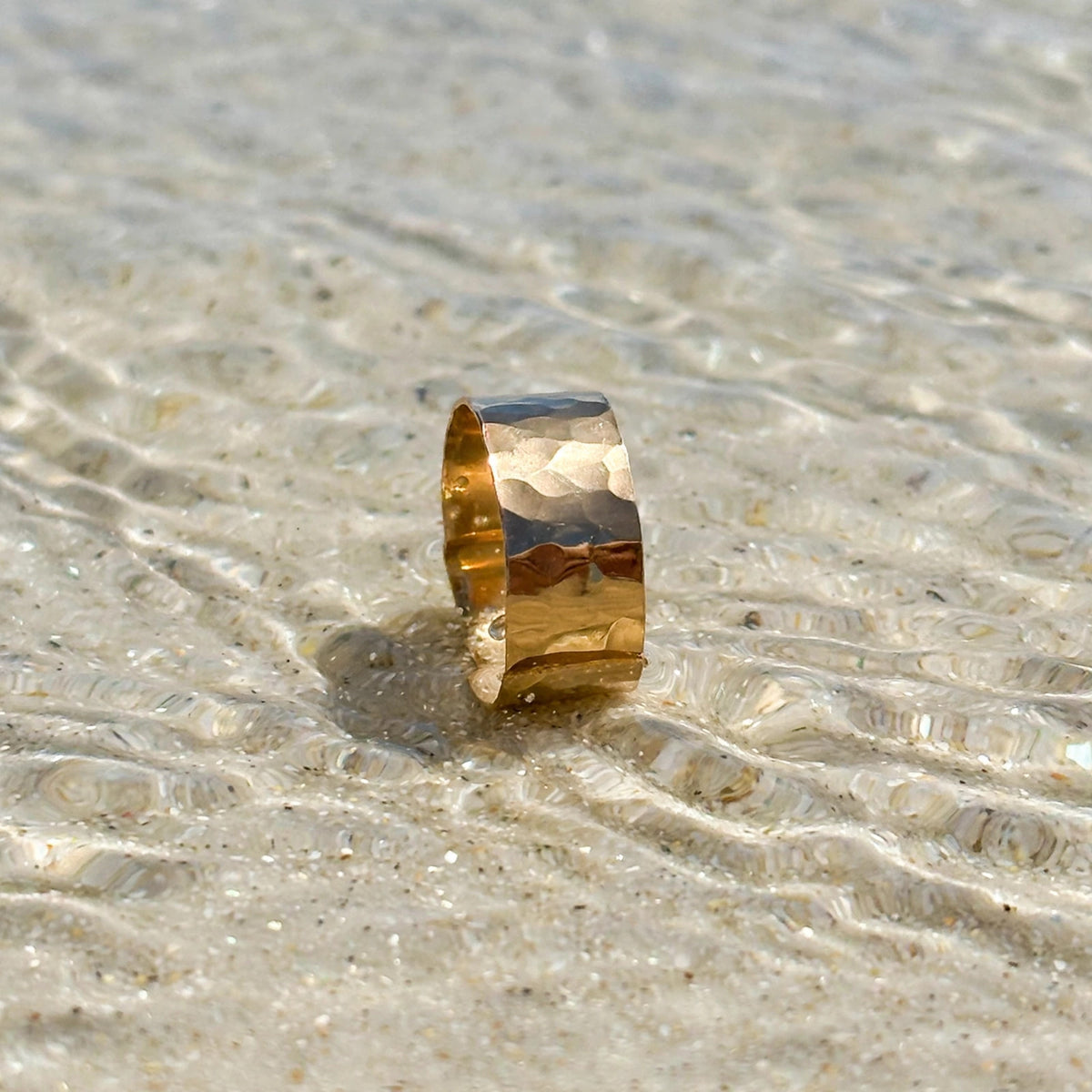 Mini Cuff Ring in 14k gold fill, styled on pale sand at the beach