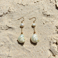 Moon and Tide Earrings in 14k gold fill, styled on pale sand at the beach
