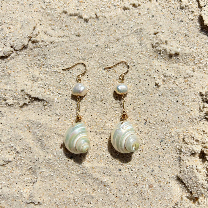 Moon and Tide Earrings in 14k gold fill, styled on pale sand at the beach