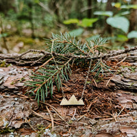Mountain Necklace in 14k gold fill with a mountain range pendant, styled on a pine branch