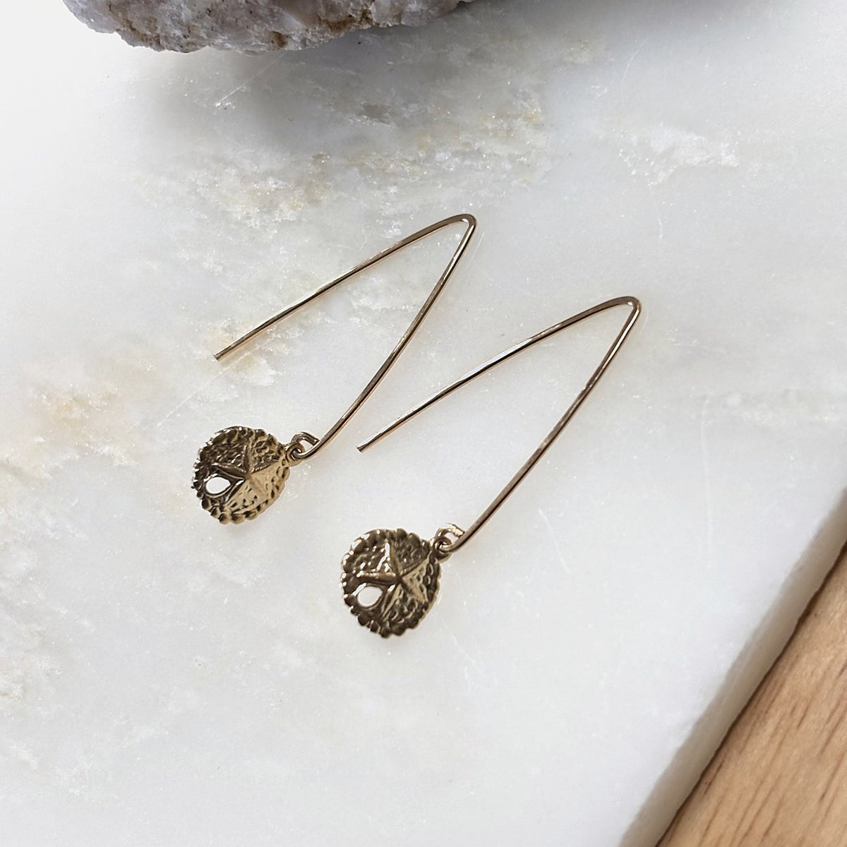 Sand Dollar Threader Earrings in 14k gold fill, second view on marble