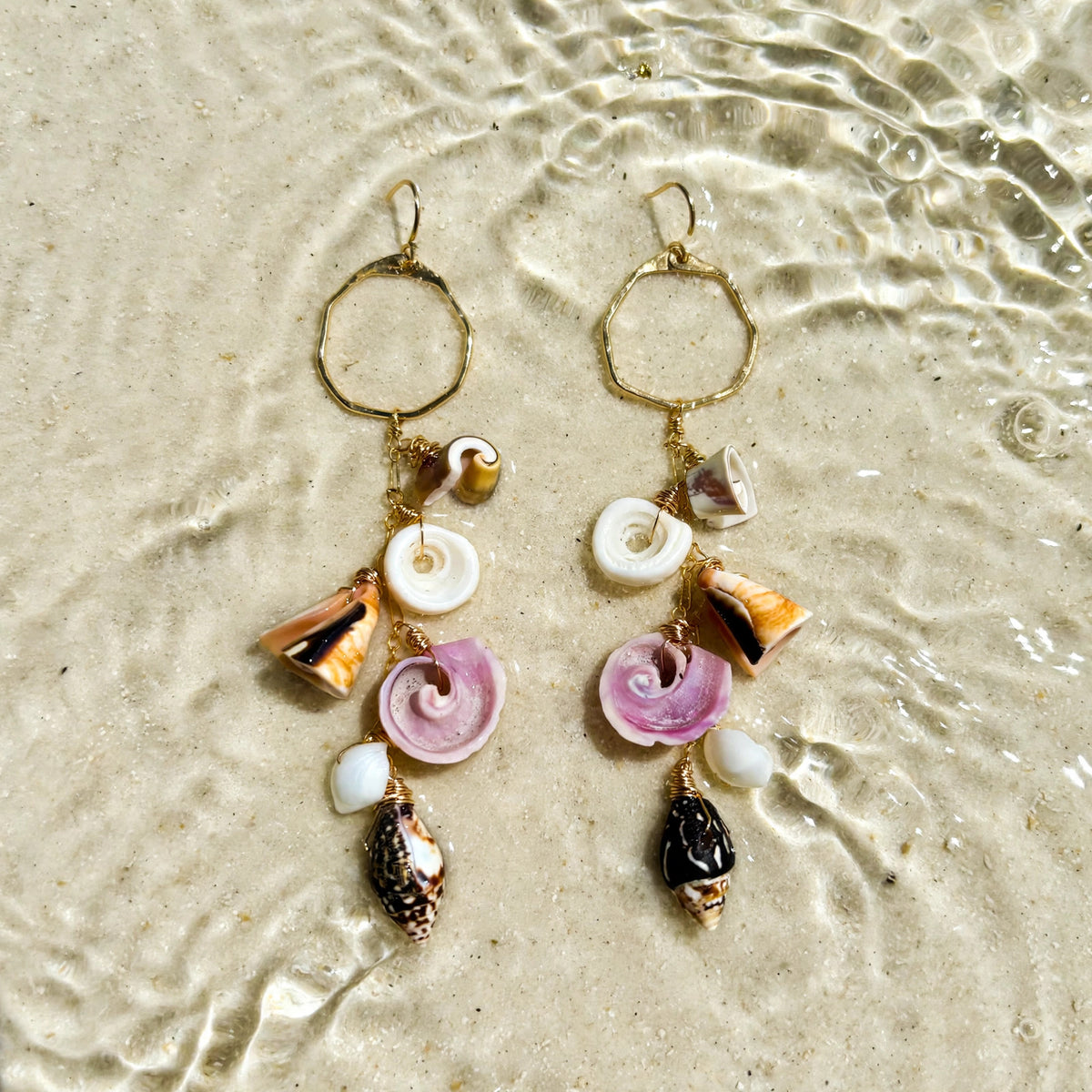 Shoreline Shells Earrings in 14k gold fill, styled on pale sand at the beach
