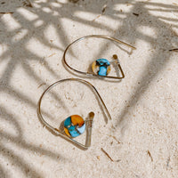 Spiny Oyster Turquoise Ear Threaders in 14k gold fill, styled on pale sand at the beach