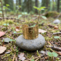 Starstruck Cuff Ring in 14k gold fill with stamped starbursts, styled on a stone