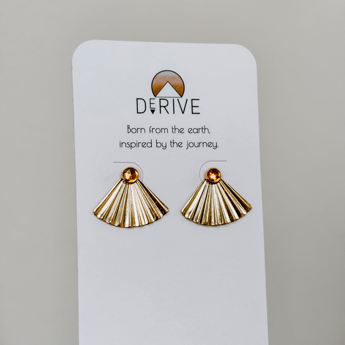 Sunset Citrine Ear Jacket Earrings in 14k gold fill with pleated fan jackets and faceted citrine studs, on a Derive earring card