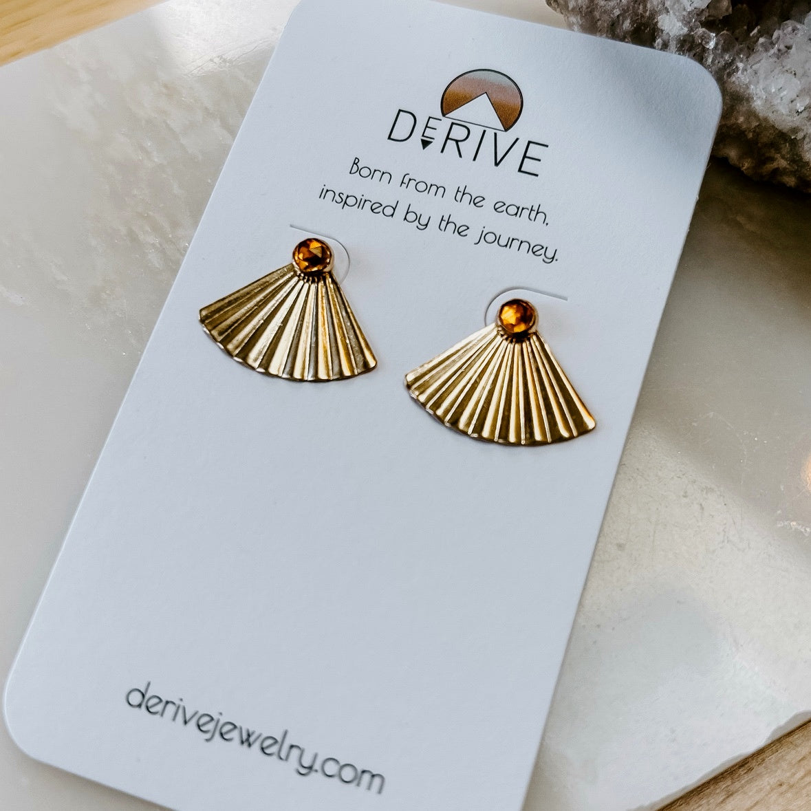 Sunset Citrine Ear Jacket Earrings in 14k gold fill with pleated fan jackets and faceted citrine studs, on a Derive earring card over marble
