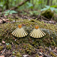 Sunset Citrine Ear Jacket Earrings in 14k gold fill with pleated fan jackets and faceted citrine studs, styled on a mossy rock