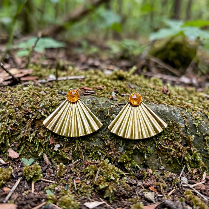 Sunset Citrine Ear Jacket Earrings in 14k gold fill with pleated fan jackets and faceted citrine studs, styled on a mossy rock