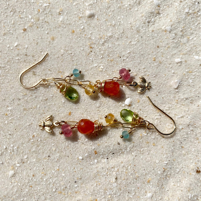 Wildflower Earrings in 14k gold fill, styled on pale sand at the beach